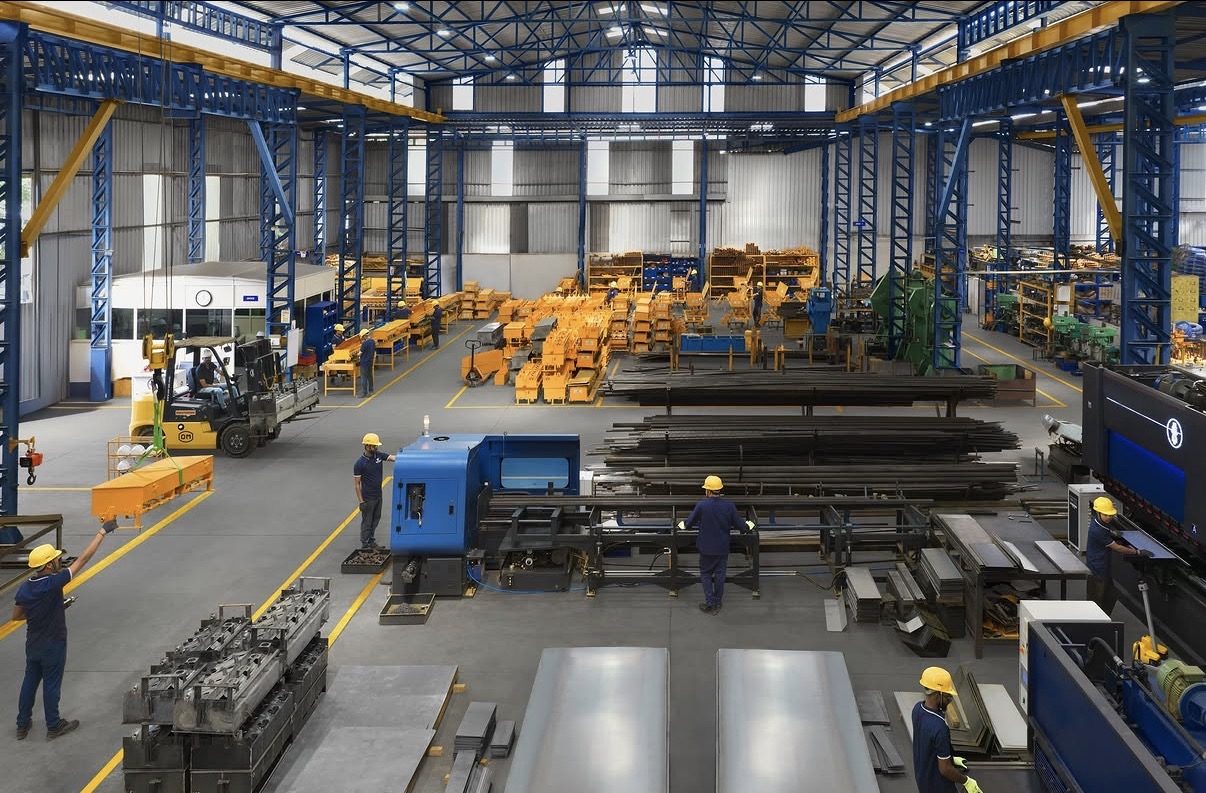 Fabrication floor with workers, steel stock and machinery
